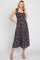 woman wearing a black floral print midi dress with tie straps and a smocked bodice
