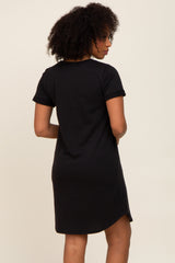 woman wearing a black short sleeve casual dress, showcasing a relaxed fit and side slits