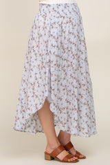 woman wearing light blue floral print midi skirt with smocked waist and brown leather sandals