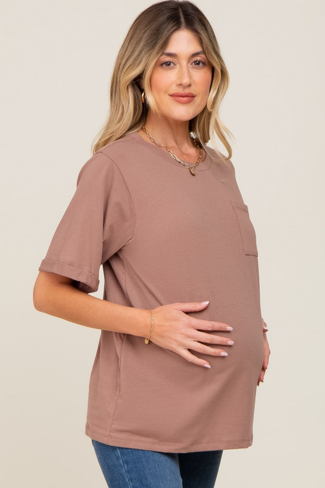Pregnant woman wearing a mauve short sleeve maternity pocket tee and gold jewelry