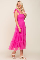 woman wearing a bright pink maxi dress with ruffle straps and tiered tulle skirt