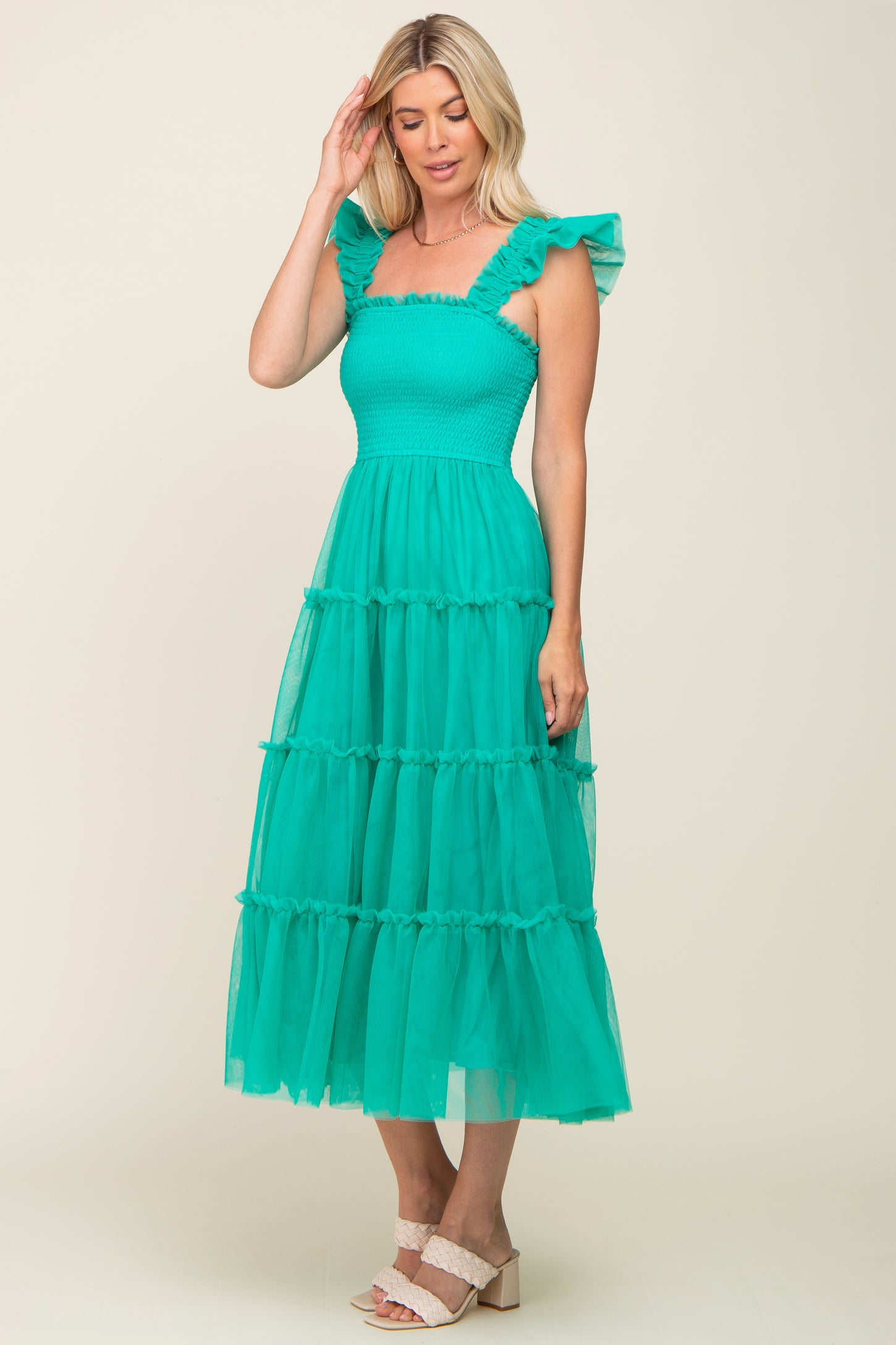 woman wearing a turquoise tiered maxi dress with ruffle straps and smocked bodice