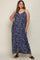woman wearing a navy blue maternity plus maxi dress with a leaf print and adjustable straps