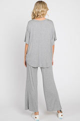 Back view of a woman wearing a grey oversized short-sleeve top and matching wide-leg lounge pants