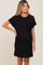 woman wearing a black short sleeve maternity dress with a pocket and a visible baby bump