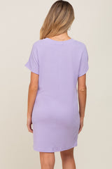 woman wearing a lavender short sleeve maternity dress shown from the back