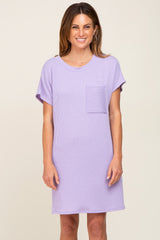 woman wearing a purple short sleeve ribbed dress with a front pocket