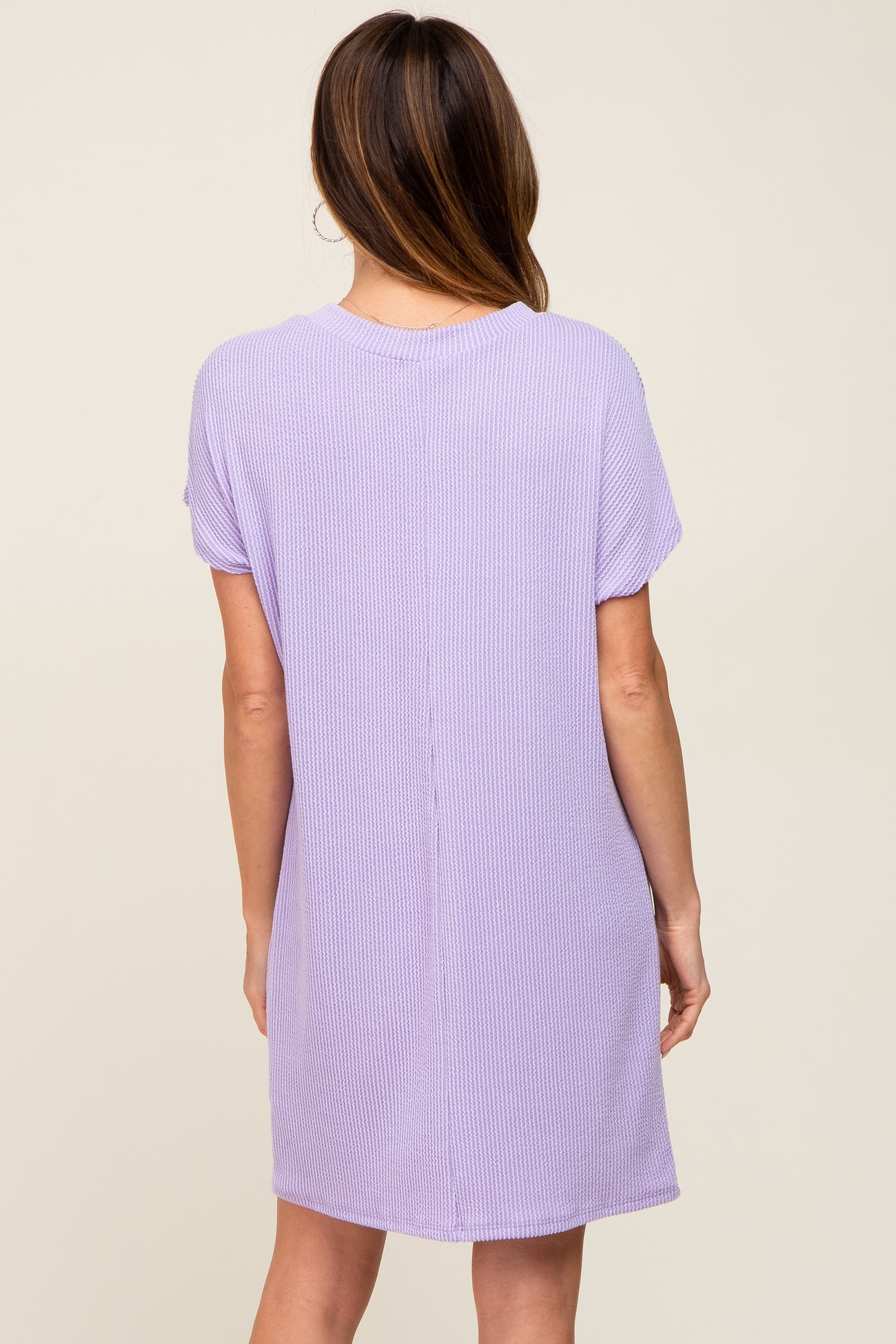 back view of a woman wearing a lavender short sleeve waffle knit shift dress