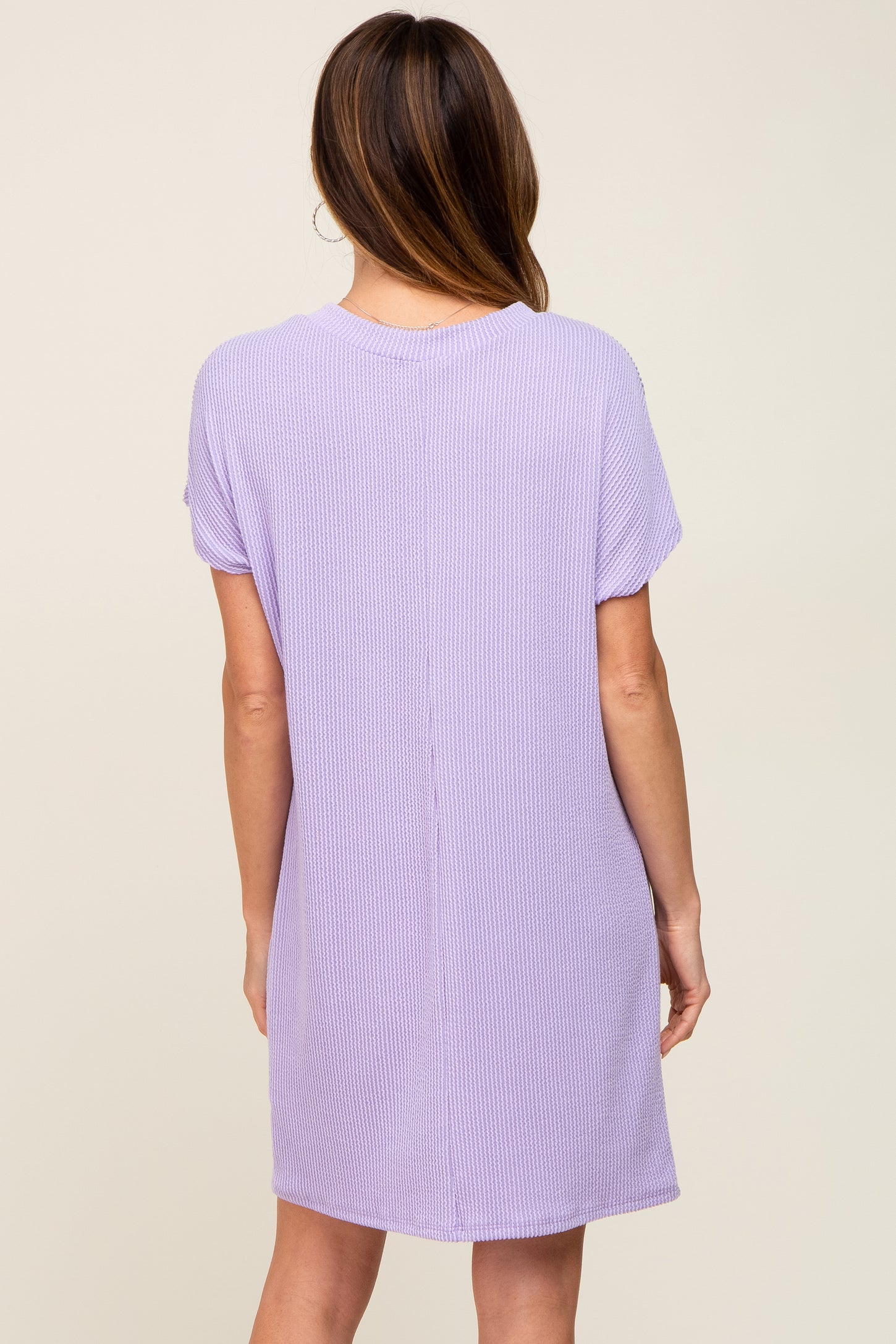 back view of a woman wearing a lavender short sleeve waffle knit shift dress