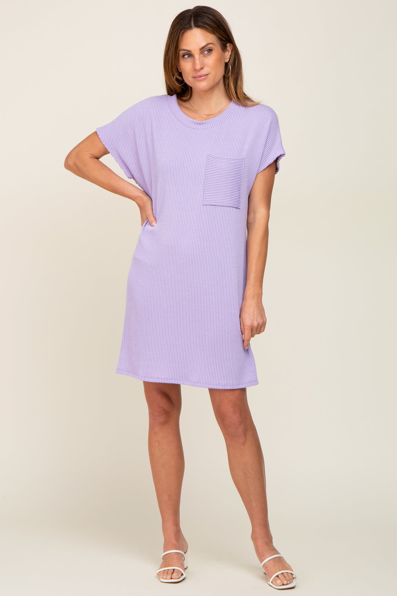 woman wearing a lavender short sleeve dress with a pocket and relaxed fit