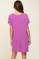 woman wearing a back view of a short sleeve pink ribbed dress