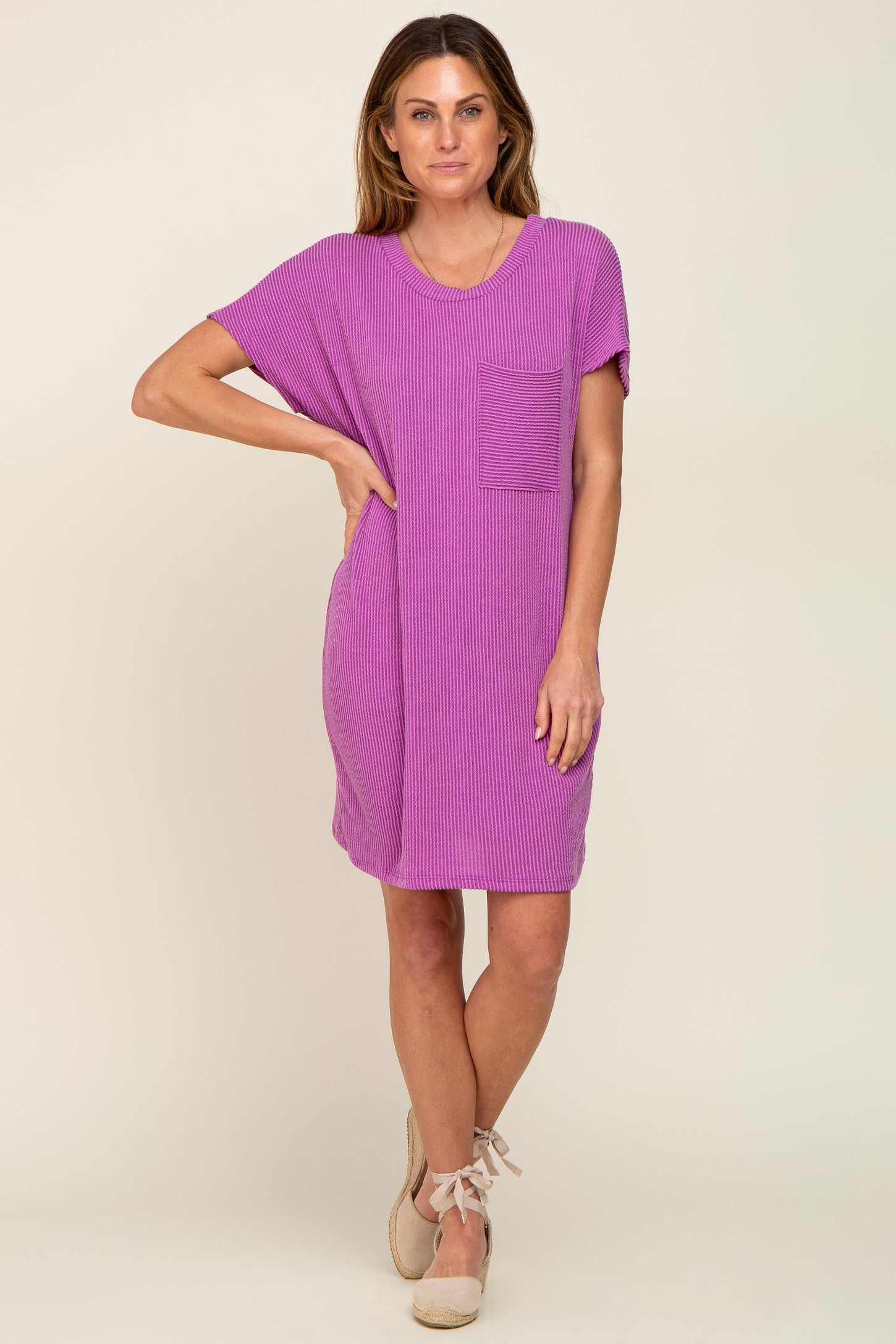 woman wearing a purple short sleeve casual dress with a chest pocket and loose fit