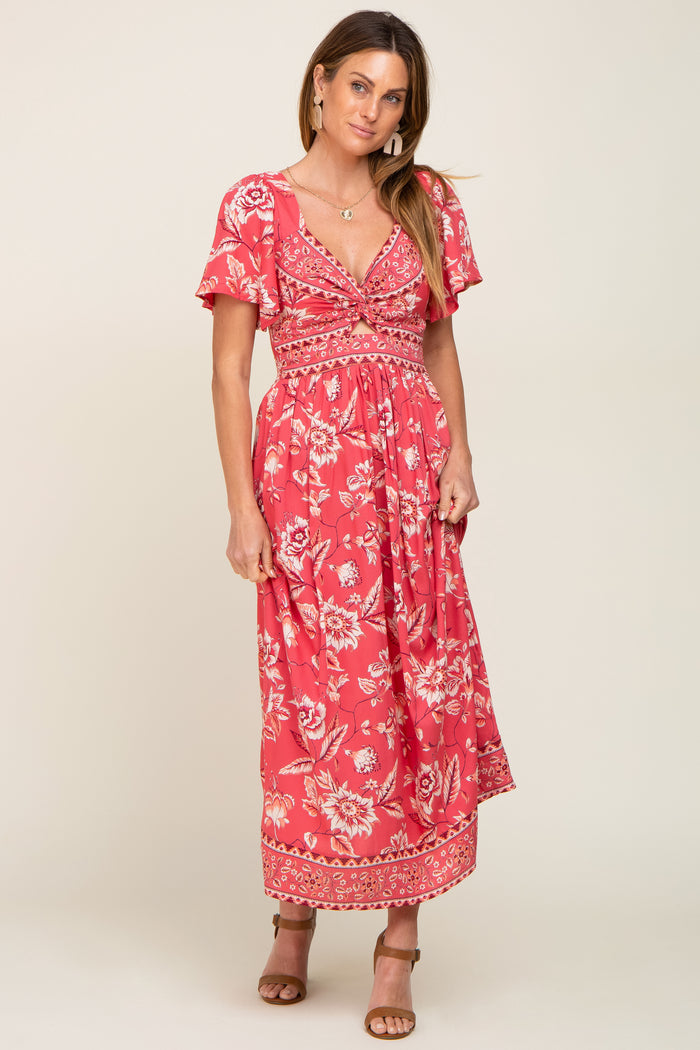 woman wearing a red floral print maxi dress with flutter sleeves and a twist front detail