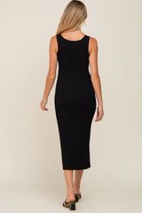 woman wearing a black ribbed maternity midi dress, showing the back view