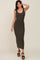 woman wearing a fitted olive green ribbed maxi dress with a scoop neckline and side slit