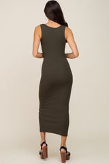 woman wearing a form-fitting olive green ribbed midi dress, showing the back view and sleek silhouette