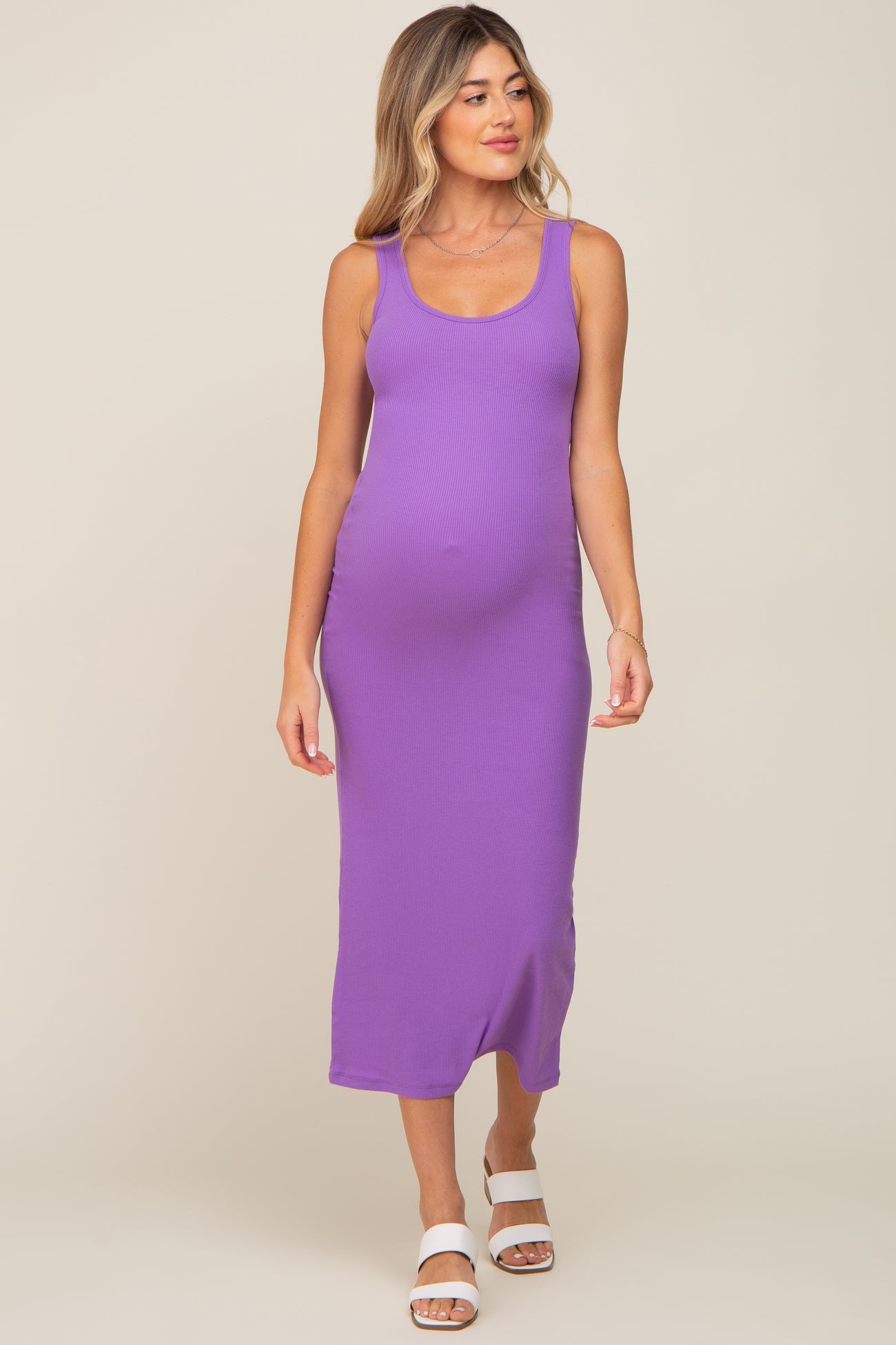 woman wearing a purple ribbed maternity maxi dress, showcasing her baby bump