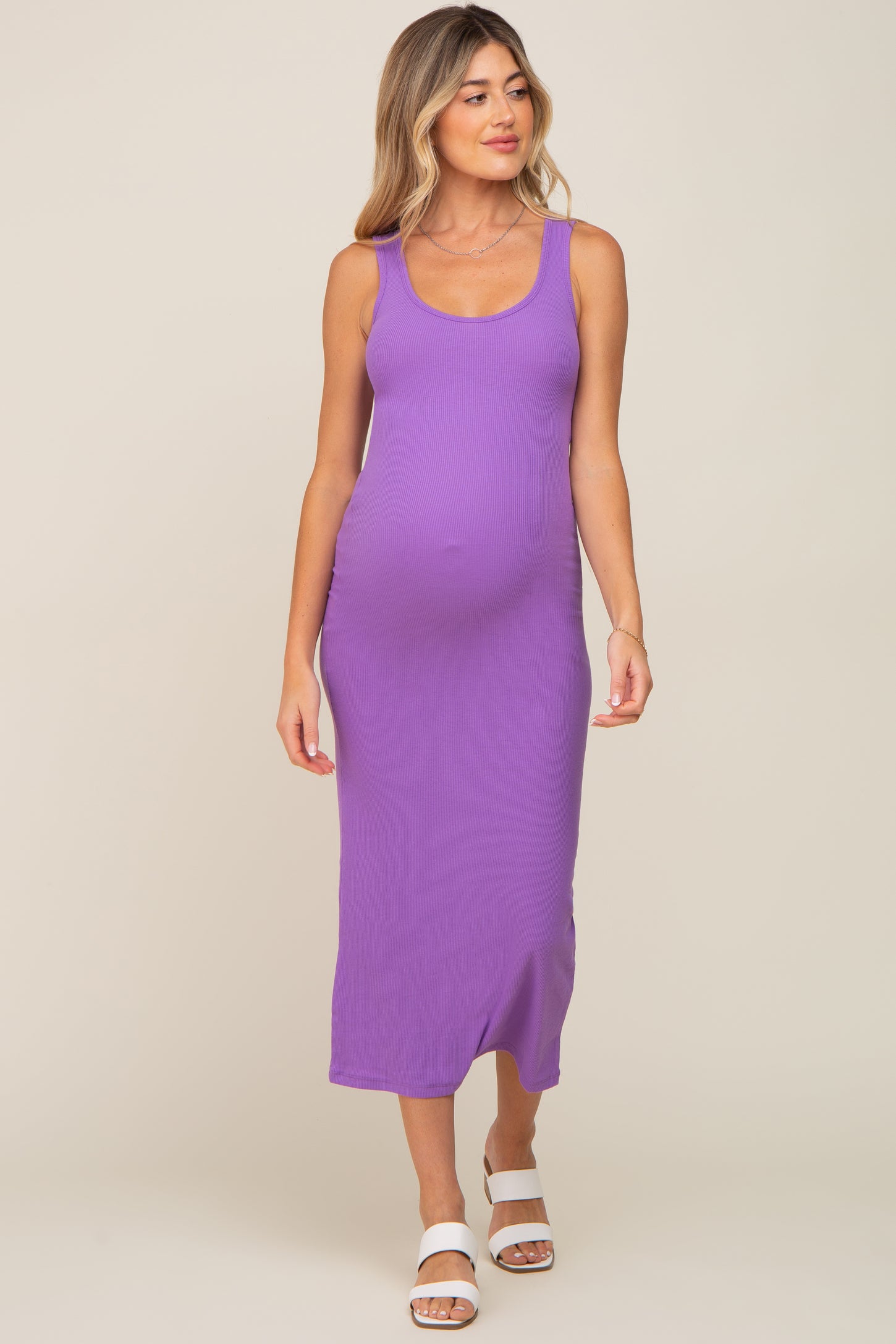 woman wearing a purple ribbed maternity maxi dress, showcasing her baby bump