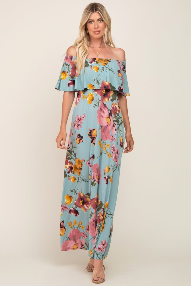 woman wearing a light blue off-the-shoulder floral maxi dress with pink and yellow flowers