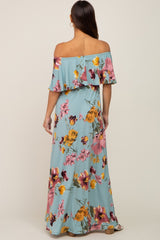 back view of woman wearing light blue off the shoulder floral maxi dress with ruffle detail