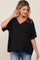 woman wearing a black v-neck maternity top with a pocket and loose fit, showcasing her baby bump