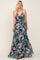 woman wearing a black floral maxi dress with a wrap design and halter neckline