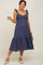 woman wearing a navy blue maternity dress with ruffled straps and a tiered skirt, showcasing her baby bump