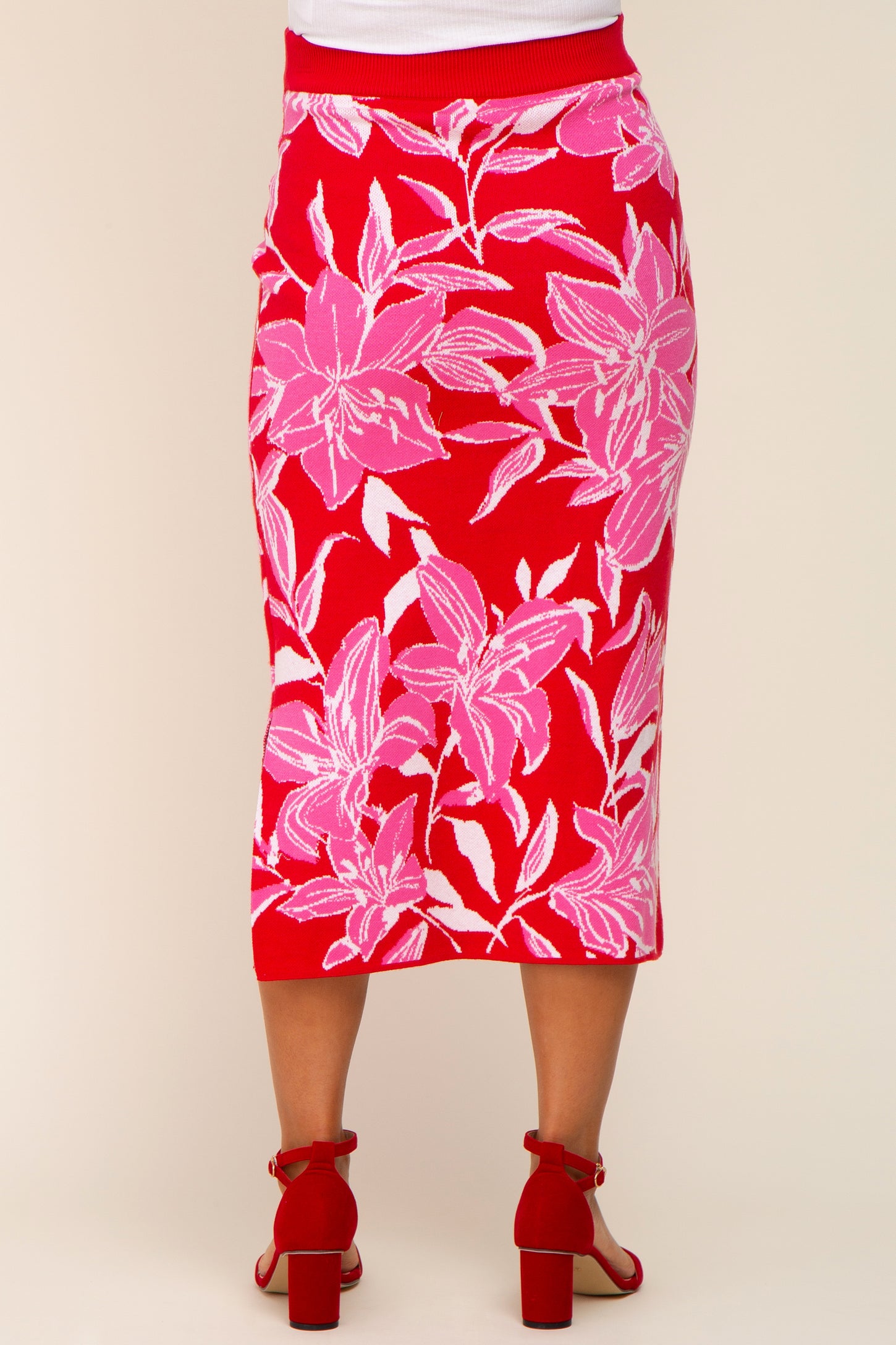 maternity wear red floral midi skirt featuring pink and white flower patterns, model showing the back view