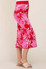 woman wearing a red floral midi skirt with pink and white patterns and a ribbed waistband