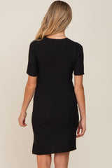 woman wearing a black short sleeve maternity dress viewed from the back