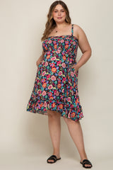 Woman wearing a plus size floral smocked maternity dress with pockets and black sandals