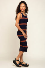 woman wearing a navy and brown striped midi dress with black platform sandals