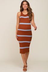 Woman wearing a rust and light blue striped ribbed knit maternity midi dress against a neutral background