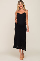pregnant woman wearing a black ribbed knit maternity midi dress with spaghetti straps and tan heels