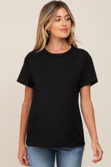 woman wearing a black maternity t-shirt with short sleeves and a relaxed fit, showing her baby bump