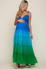 Pregnant woman wearing a blue and green ombre tiered maternity maxi dress with tie straps