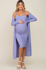 woman wearing a lavender ribbed maternity dress and long cardigan, holding her baby bump