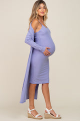 woman wearing a lavender maternity dress with a long cardigan, showcasing her baby bump and paired with wedge sandals