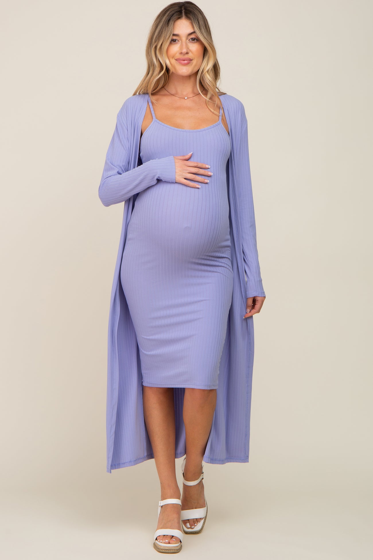 woman wearing a lavender ribbed maternity dress with a long matching cardigan, highlighting her baby bump