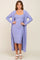 woman wearing a lavender ribbed dress with a matching long cardigan and white sandals