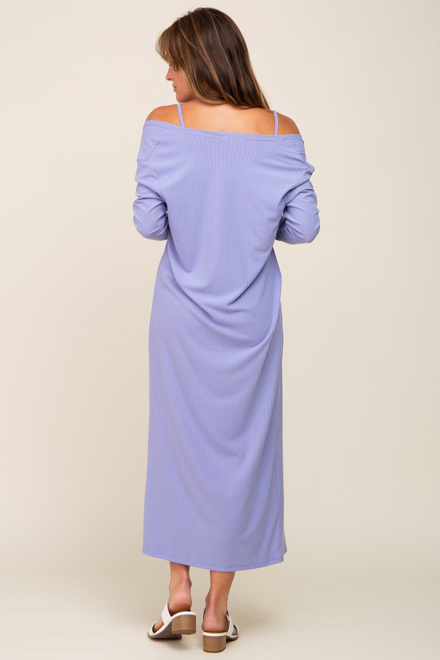 woman wearing a lavender off-the-shoulder maxi dress with long sleeves and a relaxed fit