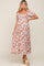 woman wearing a white floral smocked maternity midi dress with puff sleeves and tiered skirt