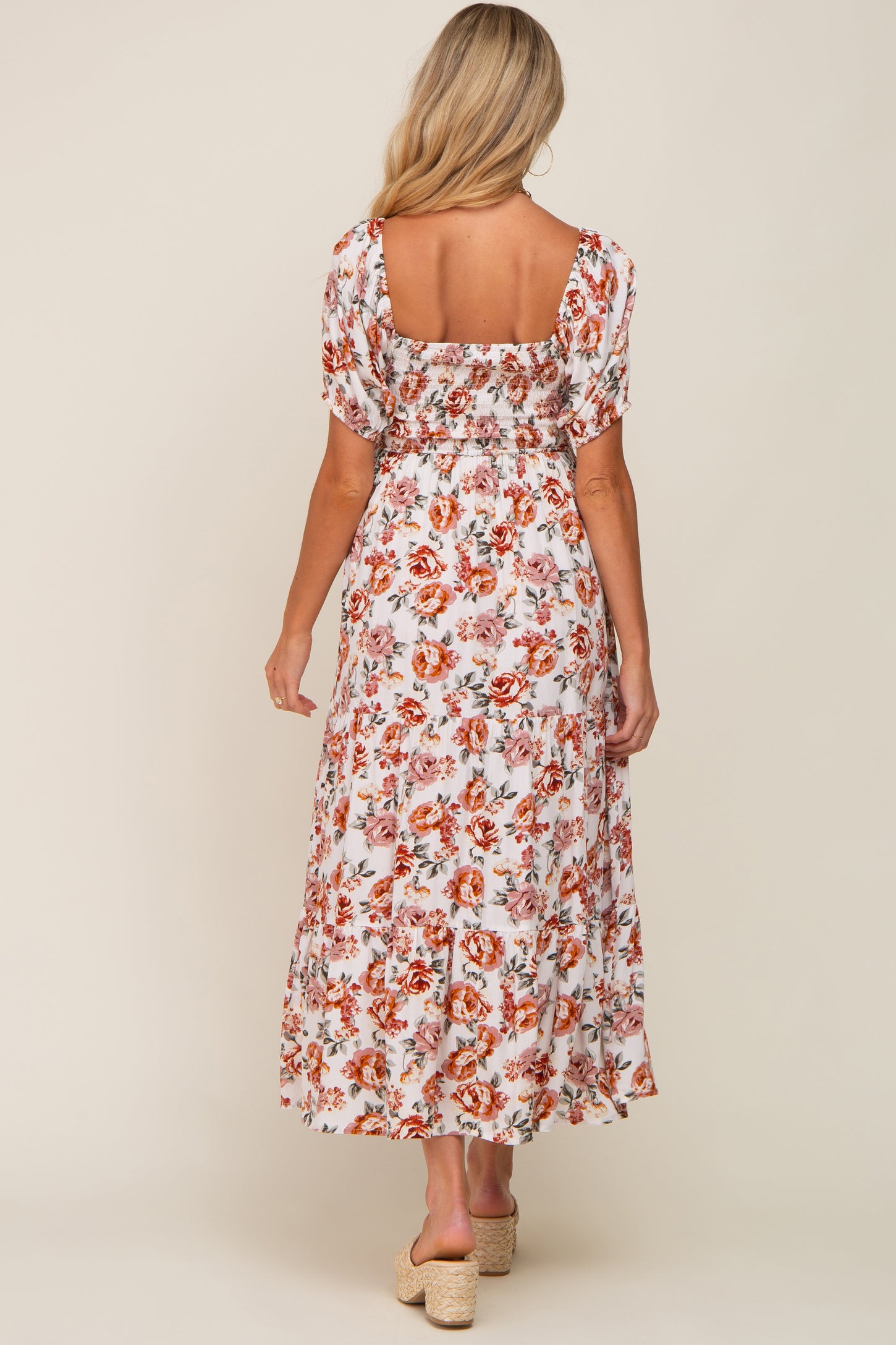 woman wearing a floral maternity maxi dress with short sleeves and a square back, showcasing a relaxed fit