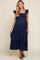 woman wearing a navy blue maternity maxi dress with ruffled sleeves and a tiered skirt, showcasing her baby bump