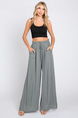 woman wearing black crop top and grey wide leg palazzo pants with drawstring waist