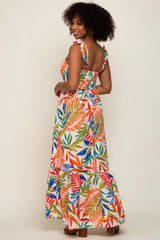 woman wearing a tropical leaf print maxi dress with tie straps and smocked back detail