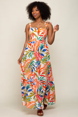 woman wearing a multicolored floral maxi dress with spaghetti straps and a tiered skirt