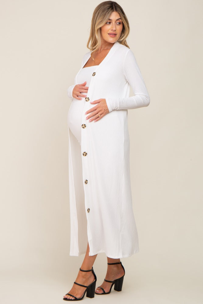 woman wearing a white long sleeve maternity dress with buttons, showcasing her baby bump