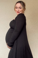 woman wearing a black ribbed maternity dress showcasing her baby bump