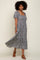 woman wearing a black and white floral print maxi dress with square neckline and short puff sleeves